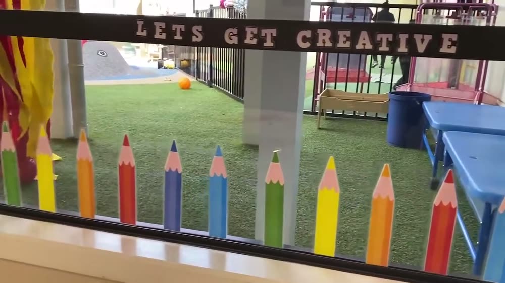 Giant coloured pencils along the Let's Get Creative area