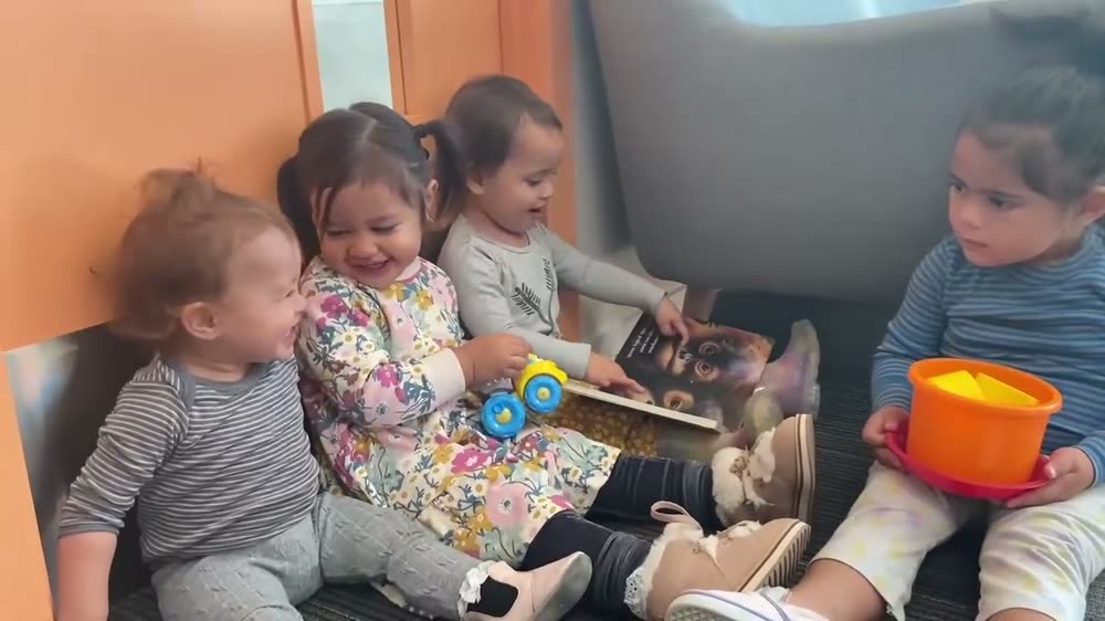A teacher-led group of children sharing a picture book together